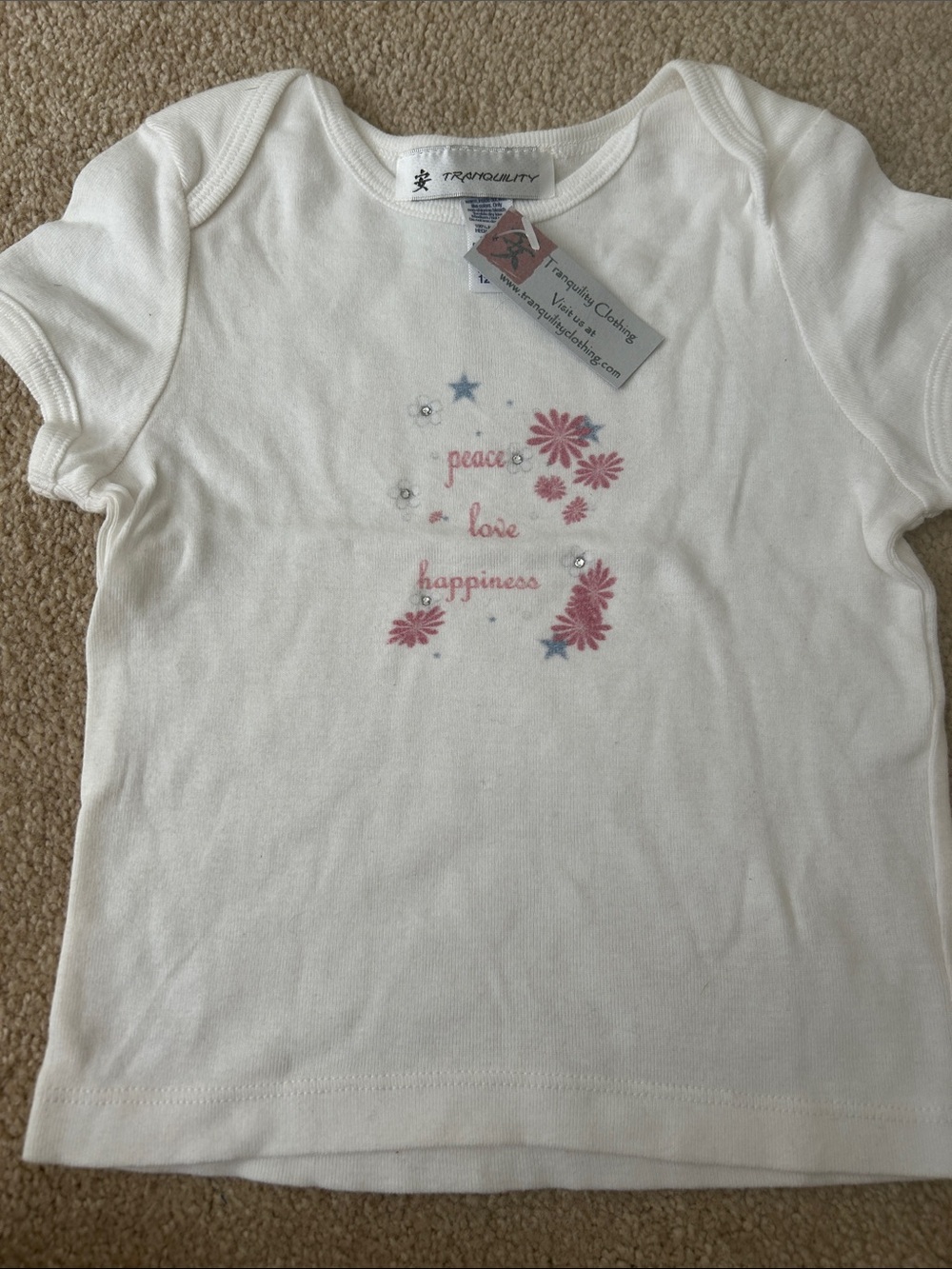 Tranquility  Clothing White Tee with Pink Floral  Accents with rhinestones.